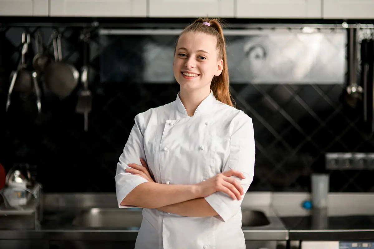 Young woman smiling in front of kitchen
