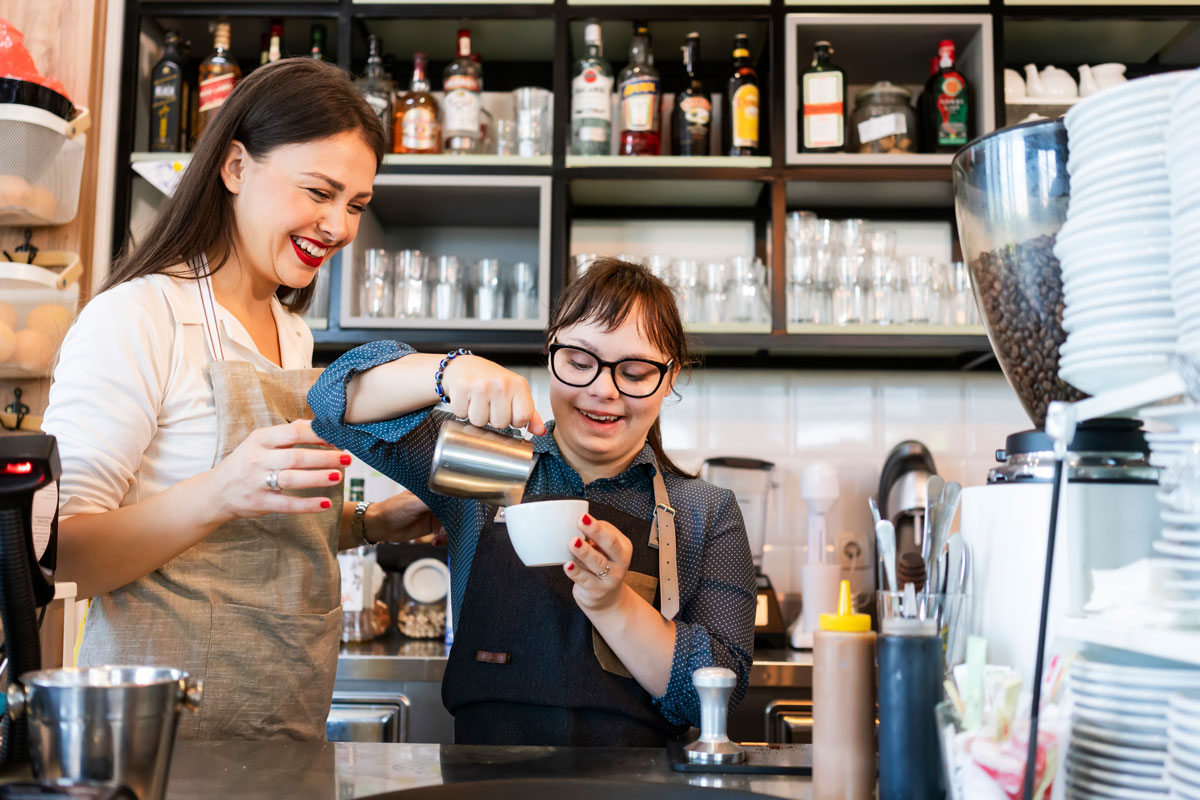 Two young women during employment training as barista