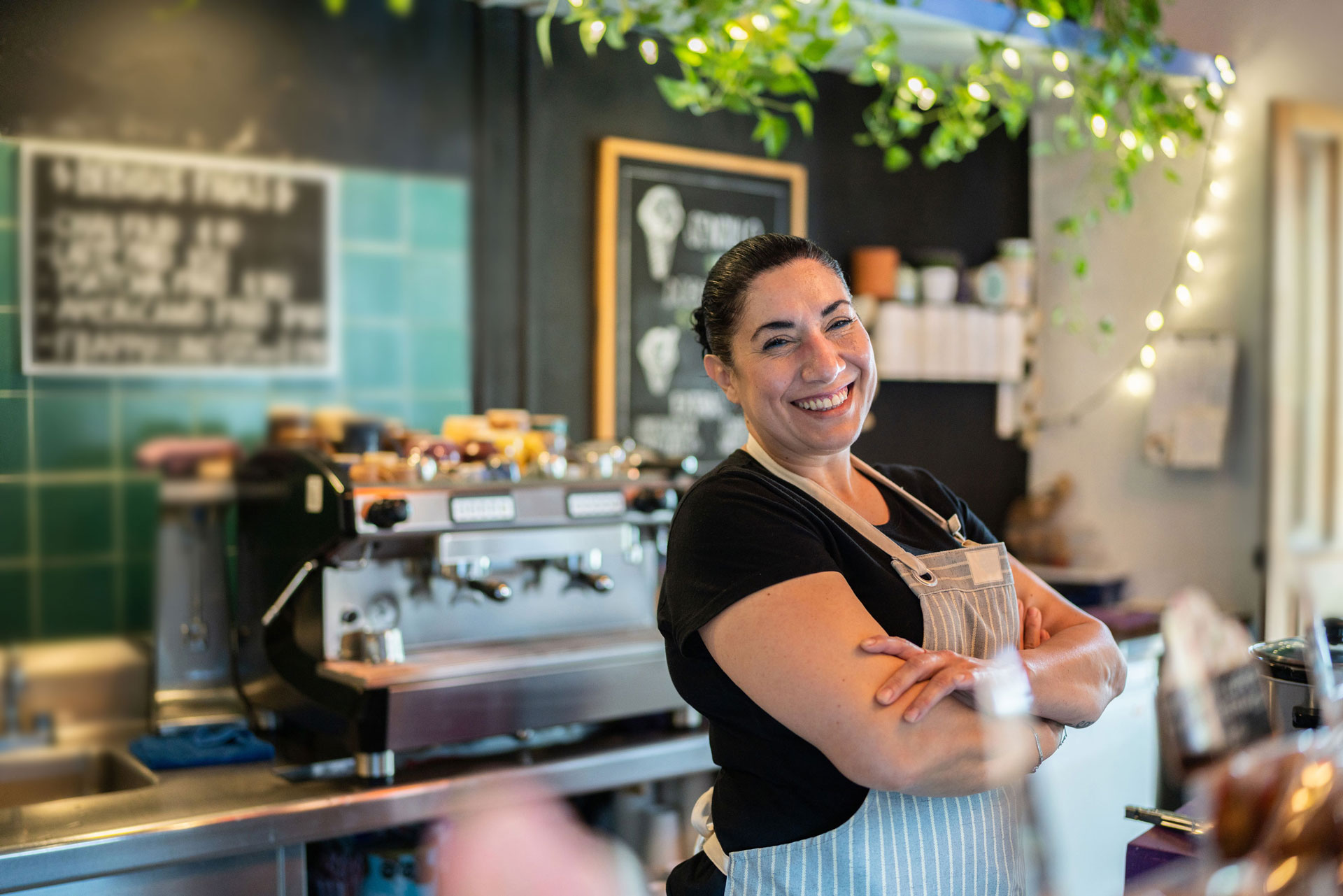 Woman business restaurant owner smiling behind counter